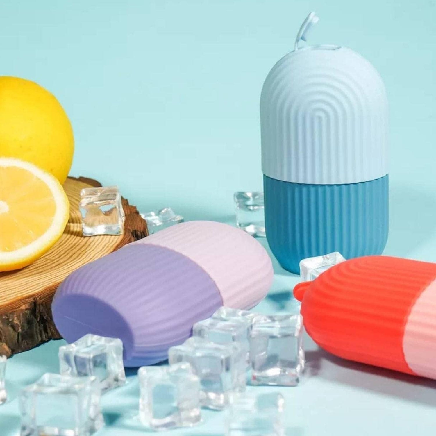 Indo Glow beauty ice roller face in pastel colors with ice cubes and lemon on a blue background