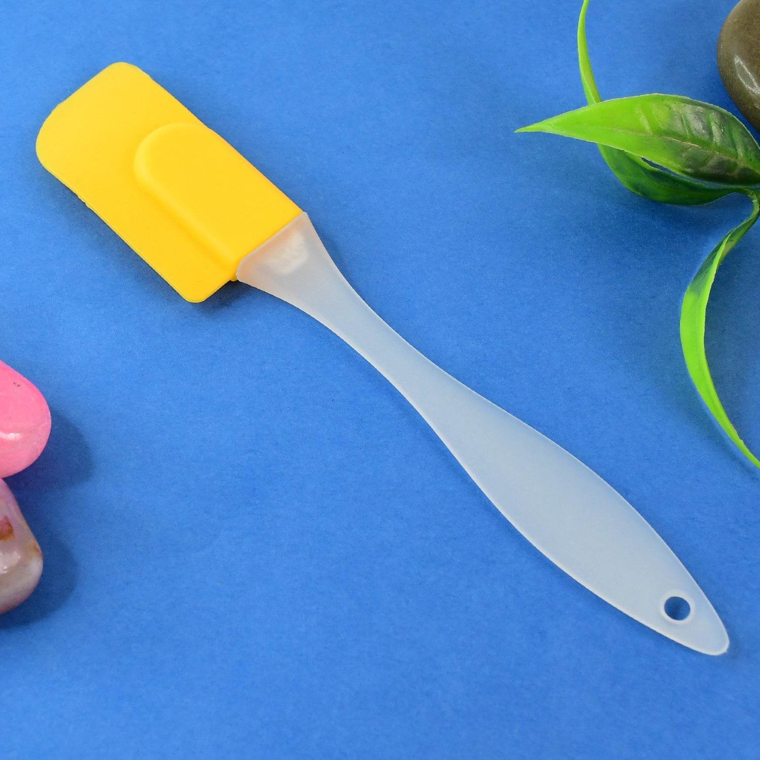 Bachat Club yellow silicone cooking spatula with translucent handle on blue background