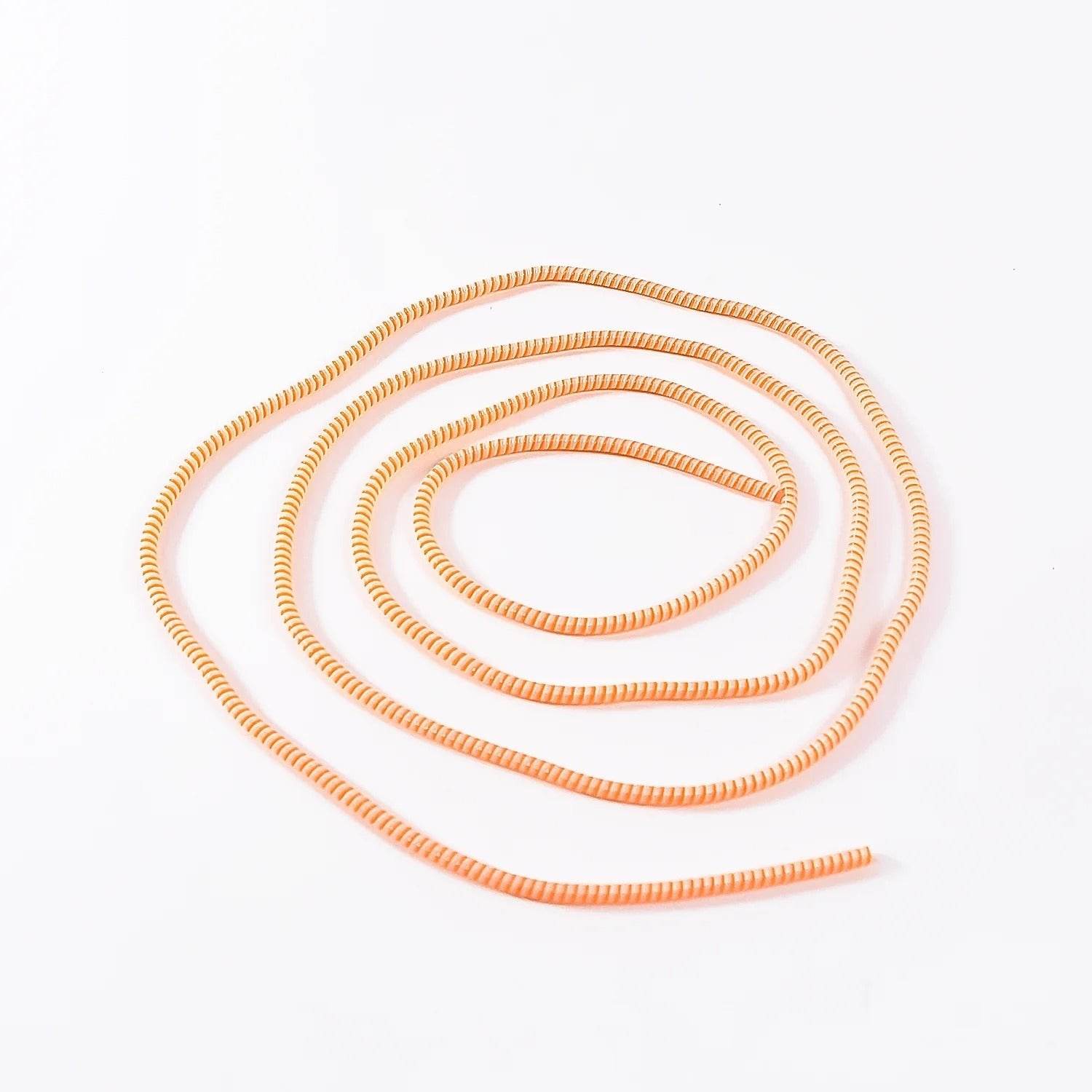 Bachat Club orange and white spiral cable protector sleeve coiled on white background