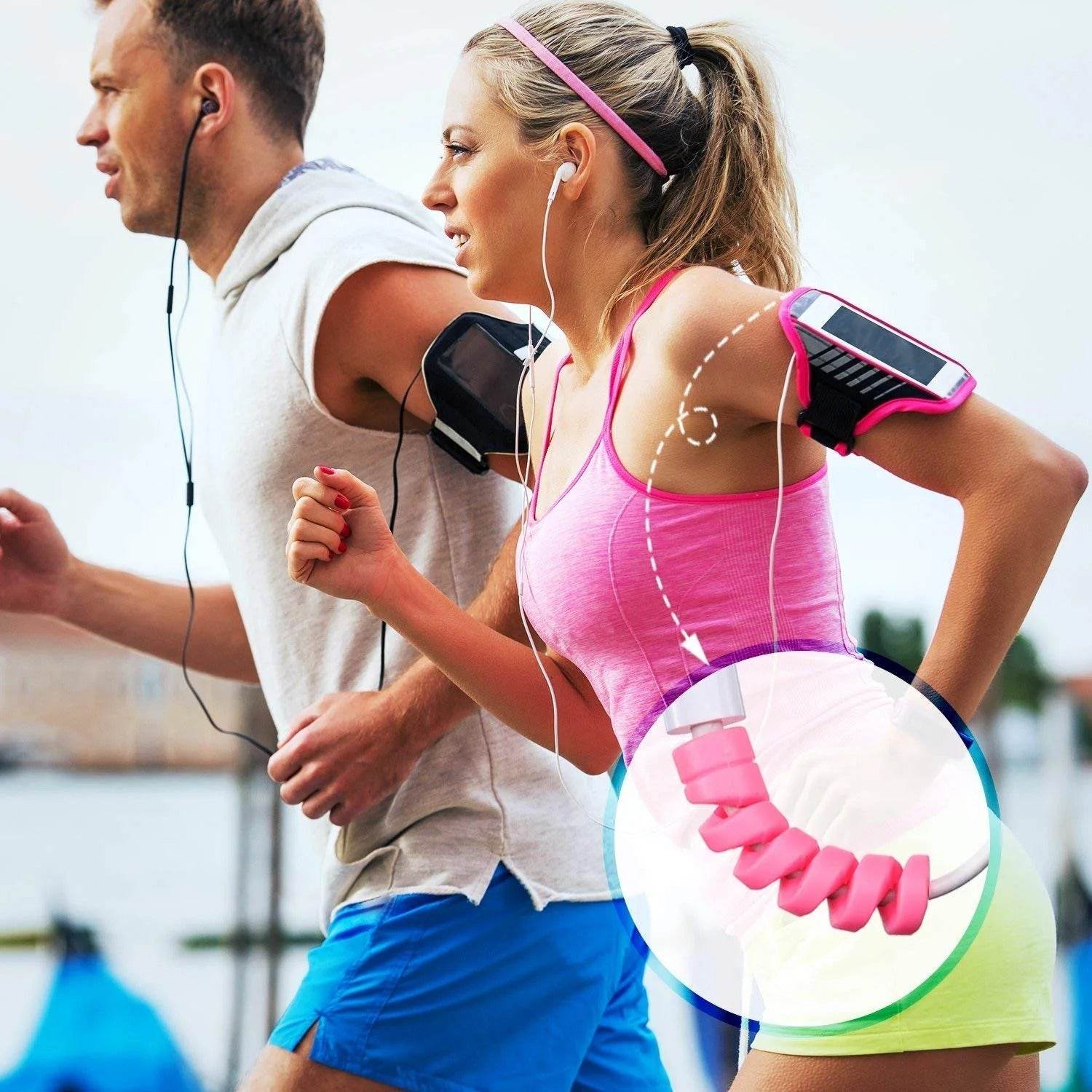 Active man and woman running outdoors with earphones and pink spiral cable protectors on cords